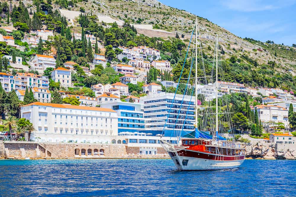 Touristic ship and hotels on shore in Dubrovnik in Croatia. Seaside resort. Landscape