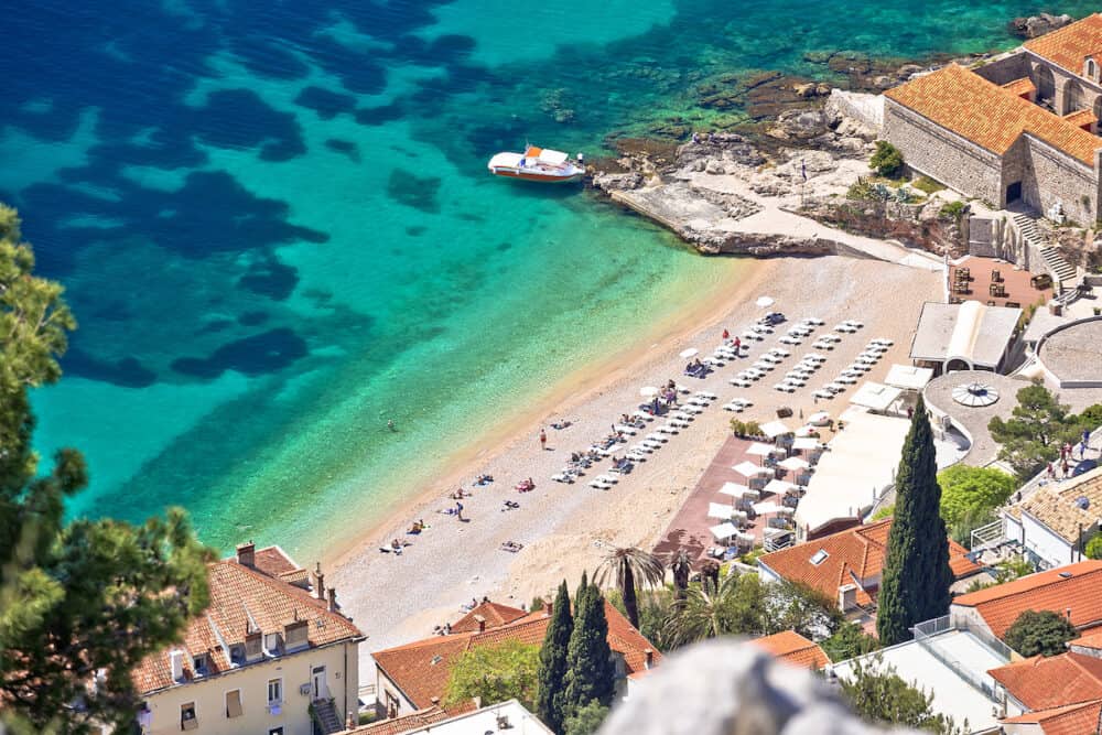 Turquoise Banje beach in Dubrovnik aerial view, famous tourist city in Dalmatia region of Croatia