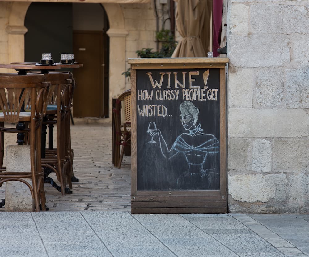 chalkboard advertising wine at an empty cafe in Dubrovnik