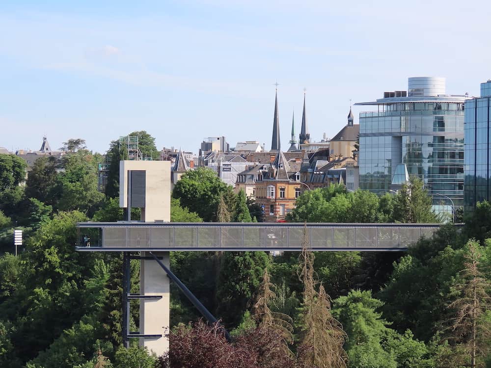 Luxembourg, Luxembourg - City view with Pfaffenthal lift, modern buildings with glass facades, old town skyline with towers of the Cathederal. Lift is part of free public transport system