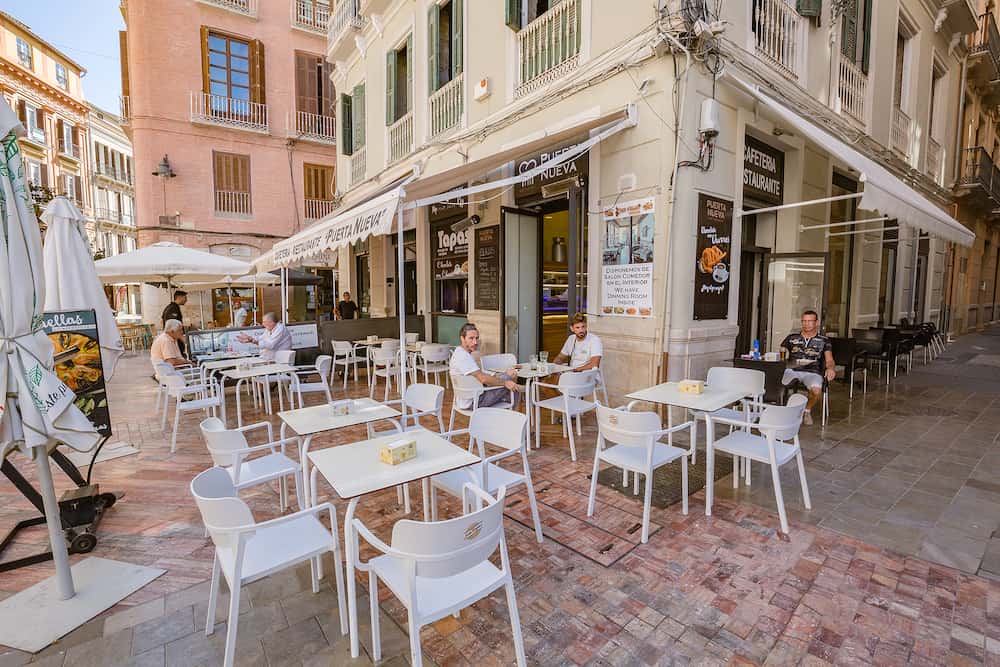 Malaga, Spain - walking Malaga old town streets. View of open air street cafe