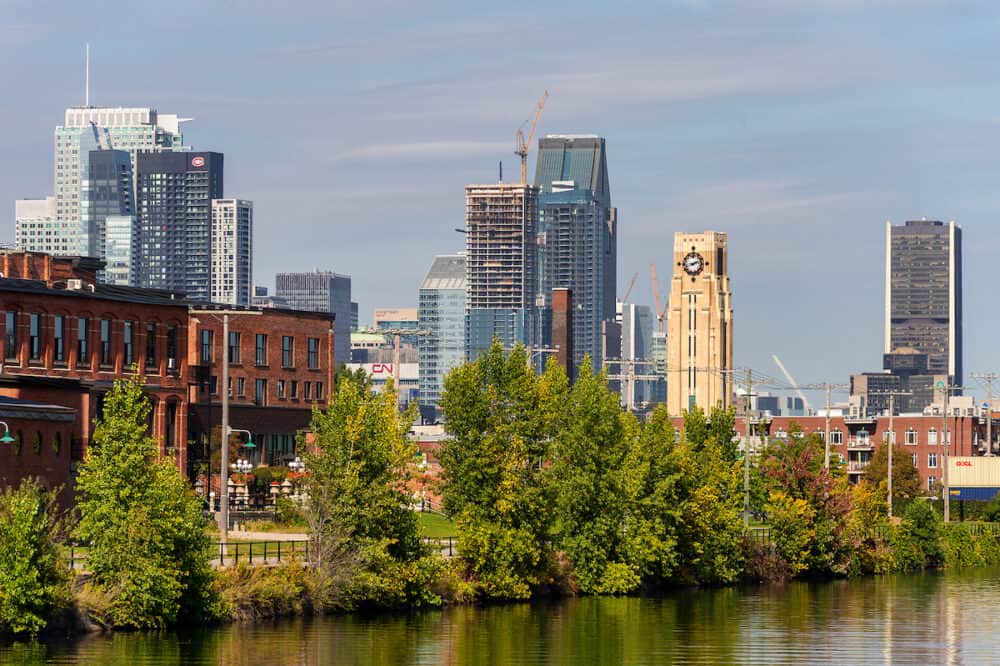Montreal, CA -  Atwater tower and Montreal Skyline from Lachine Canal.