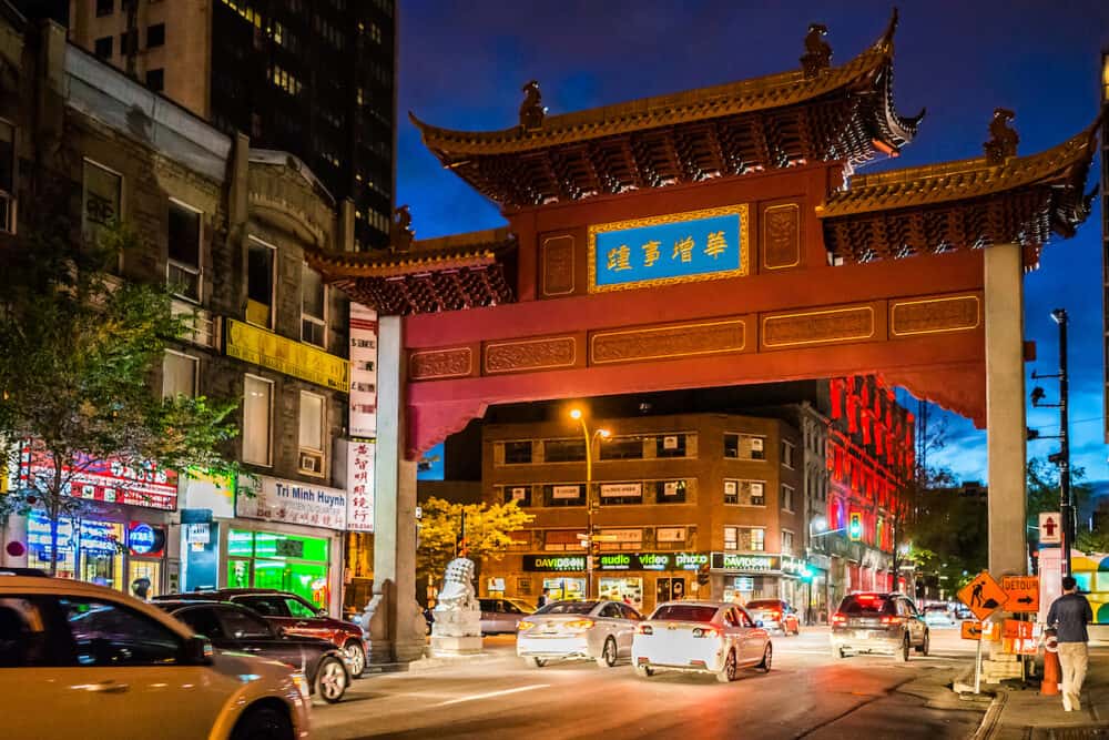 Montreal Canada -Chinatown asian downtown area at night with signs and traffic by gate entrance in evening outside in Quebec region city