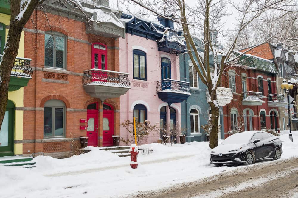 Montreal, CA -  Row houses with colorful facades in the Plateau neighborhood in Montreal, in winter.