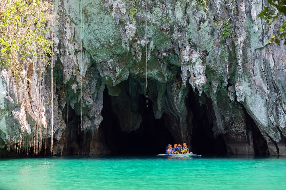 Palawan, Philippines - A boat with tourists at the entrance to the underground river in Puerto Princesa Subterranean River National Park