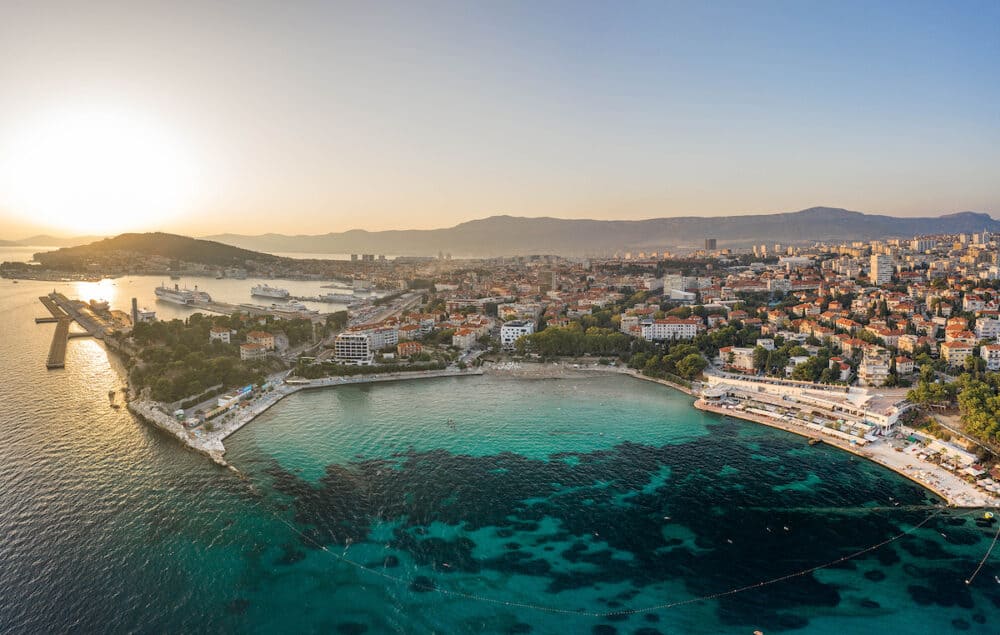 Split, Croatia - Aerial drone shot of Bavice city beach during sunset hour in summer