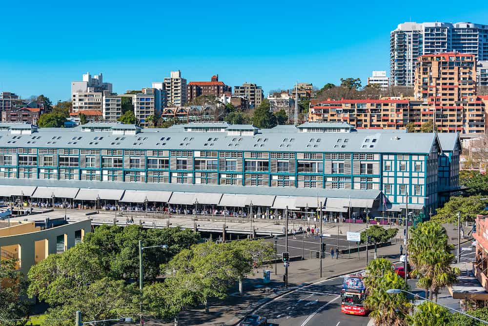 Sydney Australia - Woolloomooloo historic wharf with restaurants and hotel. Woolloomooloo district cityscape on sunny day