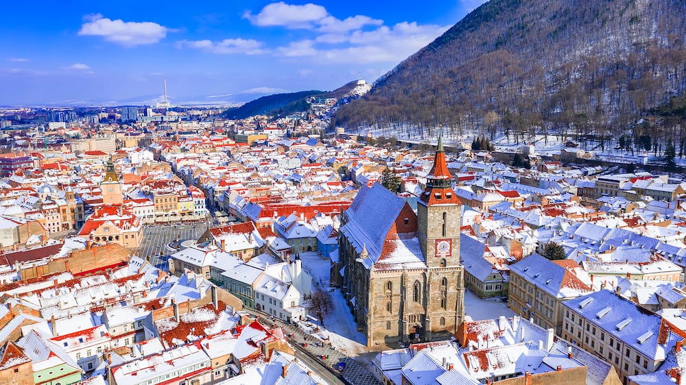 Brasov, Transylvania. Council Square and Black Church. Carpathian Mountains travel background in Romania.