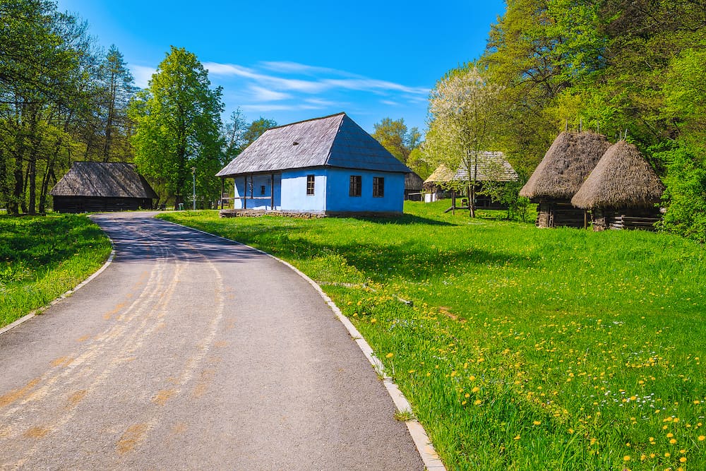 Walkway and cute old peasant houses in the Astra museum, Sibiu, Tansylvania, Romania, Europe