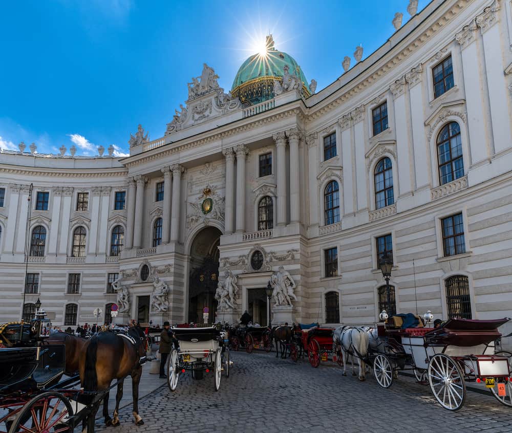 Vienna, Austria -  horse-drawn carriages outside of the historic Spanish Riding School building in Vienna