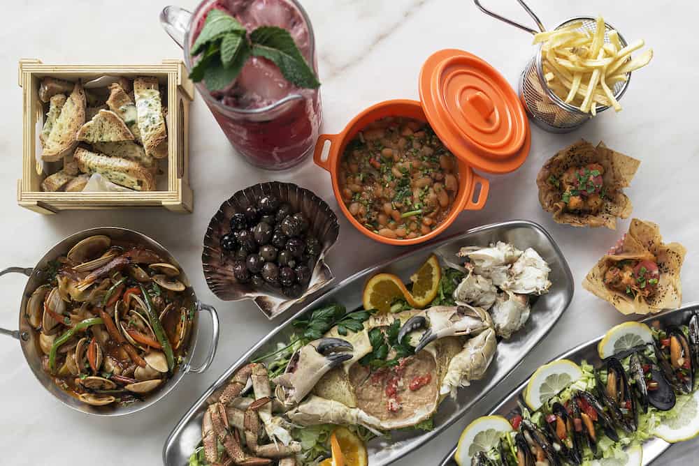 mixed fresh portuguese gourmet seafood selection set on white table 
