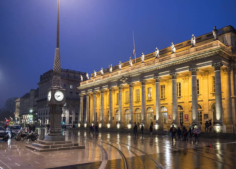 Bordeaux France - People walking in front of Grand Theatre de Bordeaux at night. The theatre is home to the Opera National de Bordeaux and the Ballet National de Bordeaux. Bordeaux Aquitaine. France.