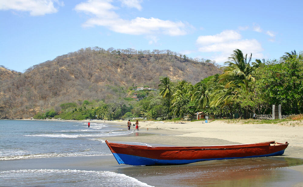 Playa Hermosa beach in Costa Rica with a boat in the foreground
