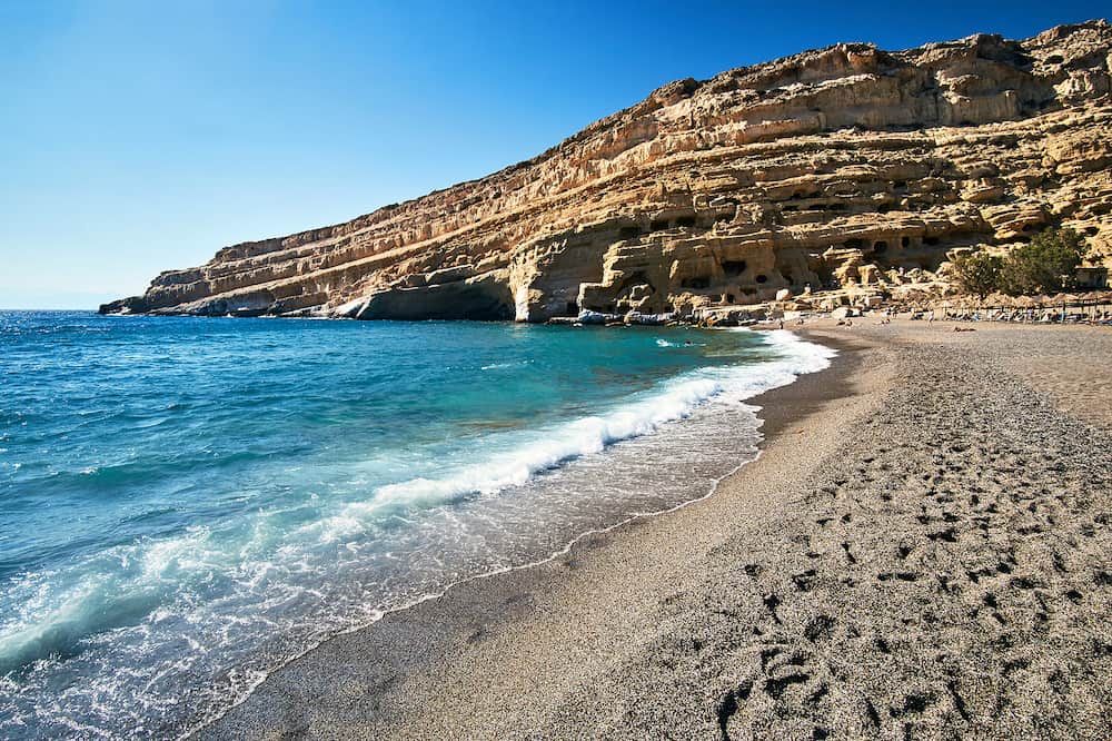 People on the sandy Matala beach on the island of Crete in Greece