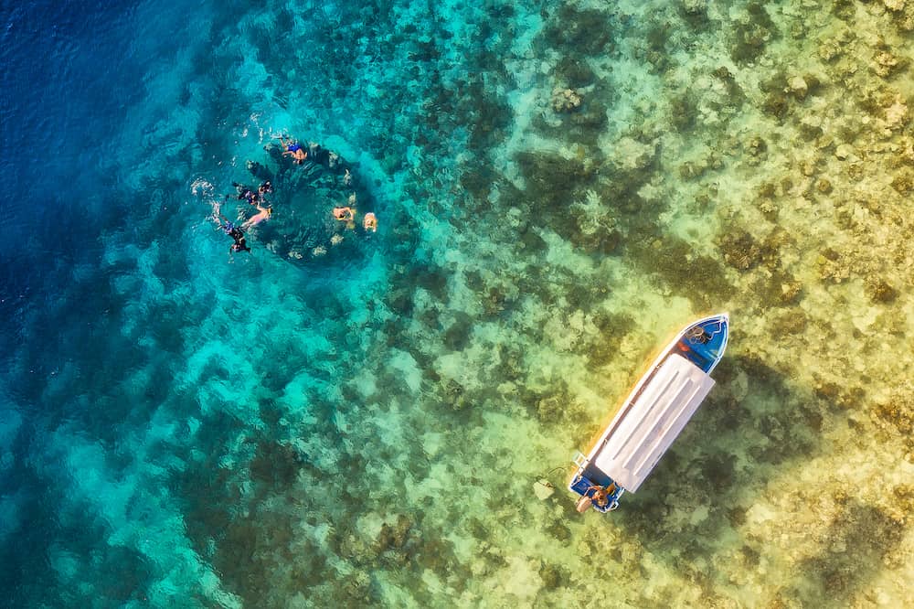 The people are snorkeling near the famous place on Gili Meno Island, Indonesia. Aerial view. Underwater tourism in the ocean. Gili Meno Island, Indonesia. Travel image