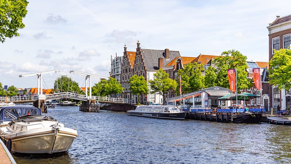 Haarlem, The Netherlands - Cityscape Haarlem with gable hosues, bridge, canal and canala cruise boat in the Netherlands