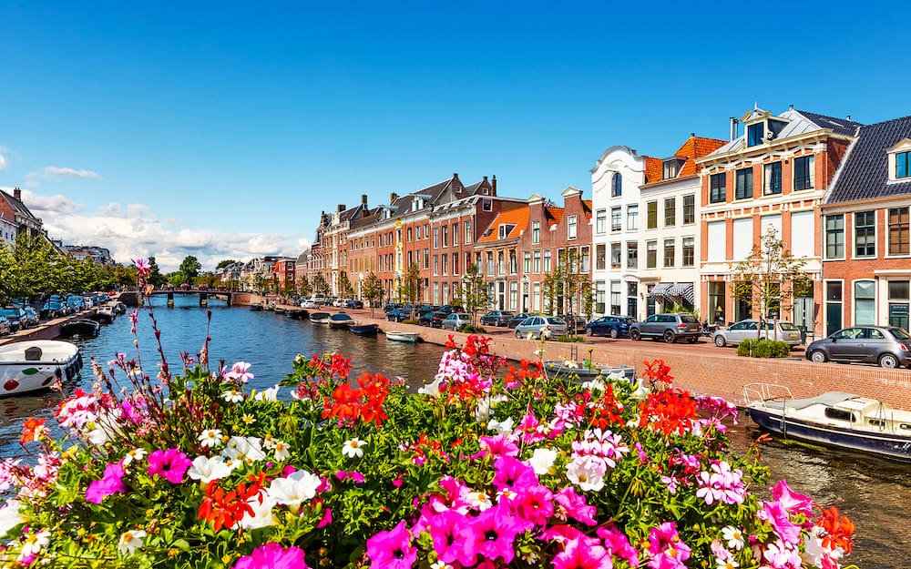 Scenic summer view of the Old Town architecture and Spaarne canal embankment in Haarlem, Netherlands