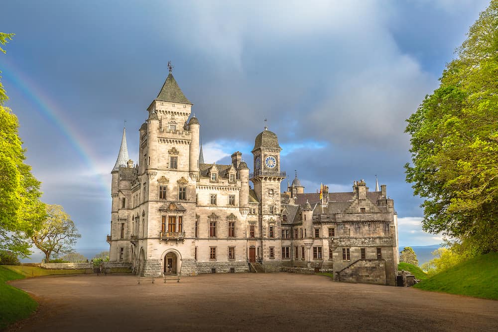 Spectacular rainbow in the dramatic sky at the scenic Dunrobin Castle in Scotland. Northern Highlands in Golspie, the east coast of Scotland, United Kingdom.