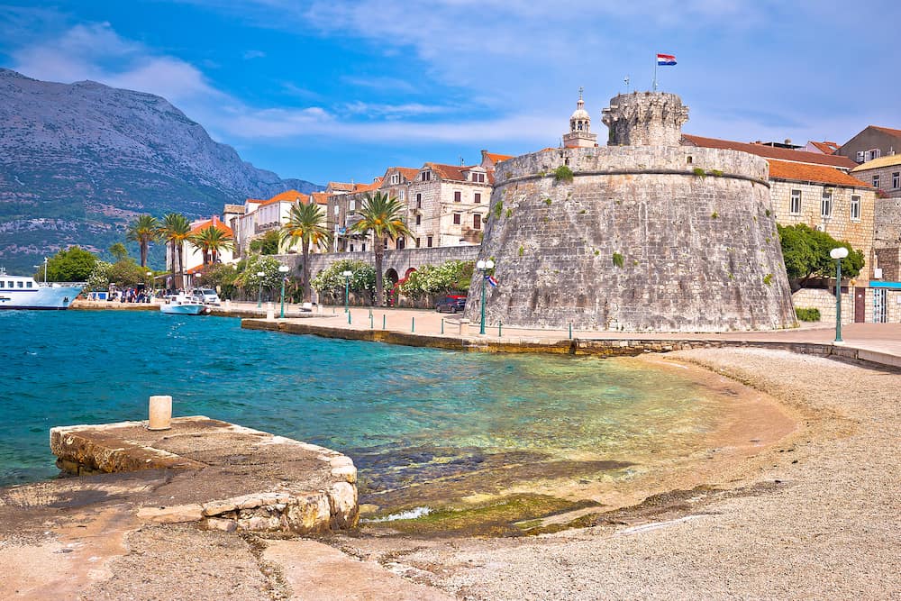 Historic island town of Korcula beach and stone walls view, southern Dalmatia archipelago of Croatia
