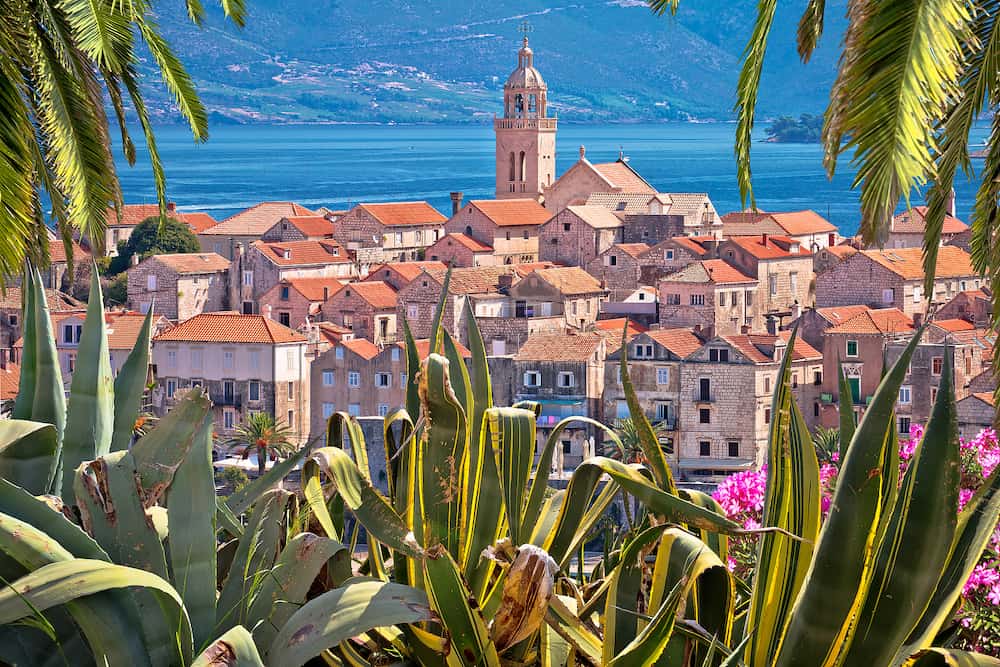 Historic town of Korcula panoramic view through natural frame, island in archipelago of southern Croatia