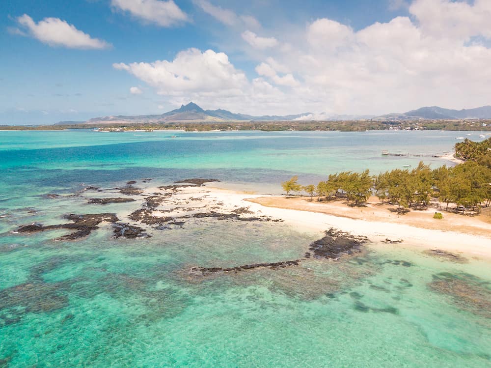 Aerial view of beautiful tropical beach with turquoise sea. Tropical vacation paradise destination of Deau Douce and Ile aux Cerfs Mauritius