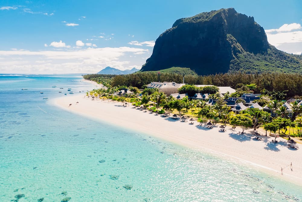 Luxury tropical beach and Le Morne mountain in Mauritius. Beach with palms and transparent ocean. Aerial view
