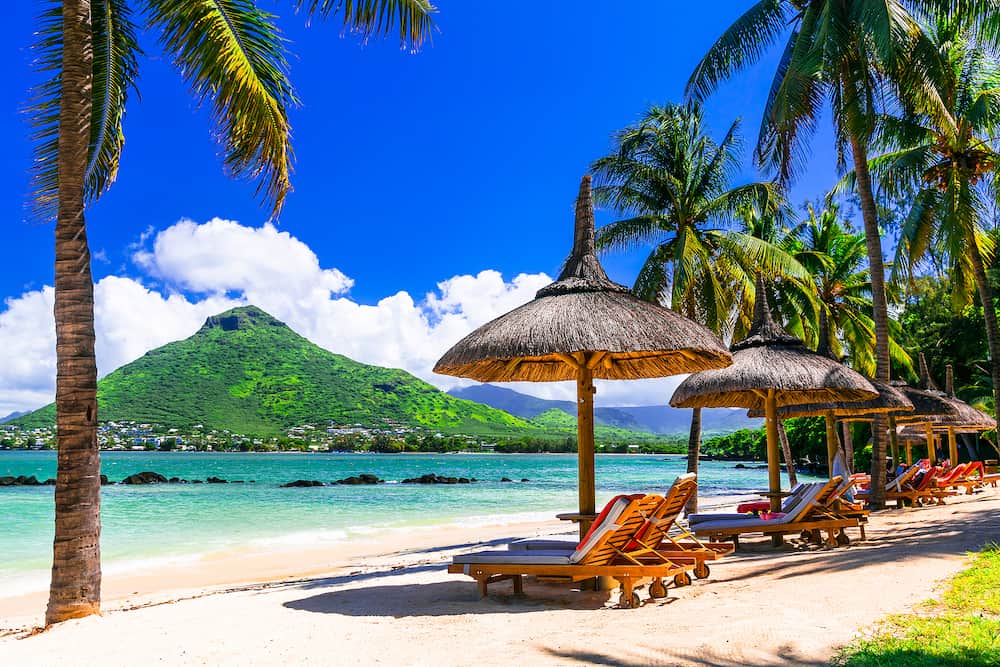 Relaxing holidays in tropical paradise. Mauritius island. Flic en Flac beach, view of Tamarin mountain