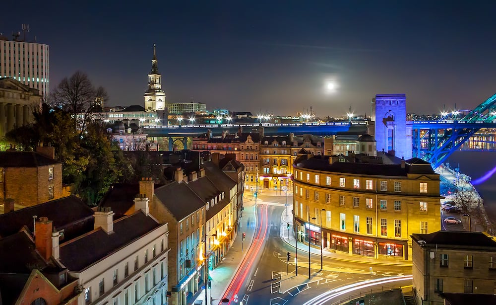 Rooftop Aerial View of Vibrant British City Skyline under Night Sky with Full Moon, Newcastle upon Tyne, UK