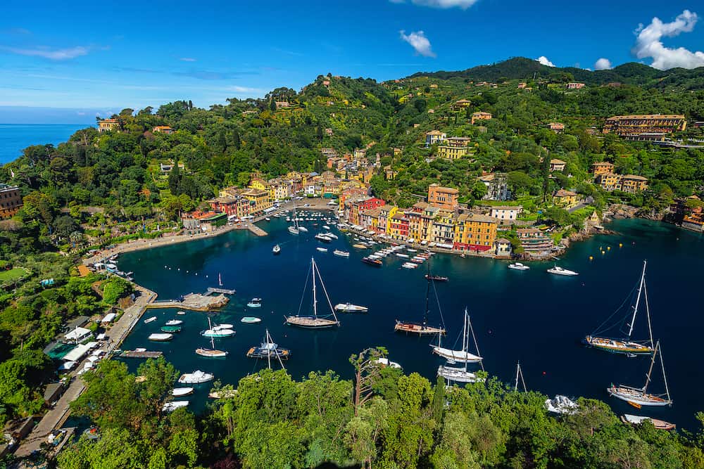 Stunning vacation and travel destination in Liguria. Portofino view with colorful mediterranean buildings and luxury boats, yachts from the castle of Brown, Portofino, Liguria, Italy, Europe