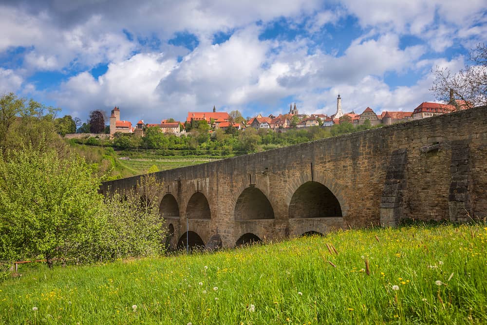 Medieval stone double bridge over Tauber at Rothenburg ob der Tauber, Bavaria, Germany, Europe, one of the most popular travel destination on Romantic Road touristic route