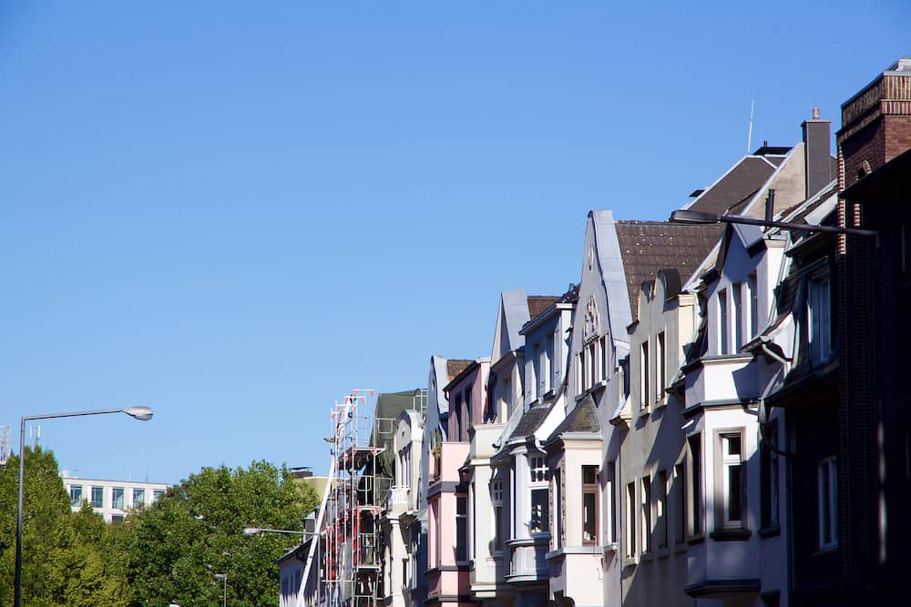 Historic Renaissance Revival architecture in the Frankenberger Quarter Aachen Germany with townhouses with ornate stone carving and dormer windows against a blue sky
