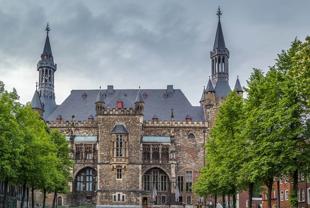 The Gothic Aachen Rathaus or Aachen City Hall lies next to the Aachen Cathedral and is one of the most striking structures in the Altstadt of Aachen Germany.