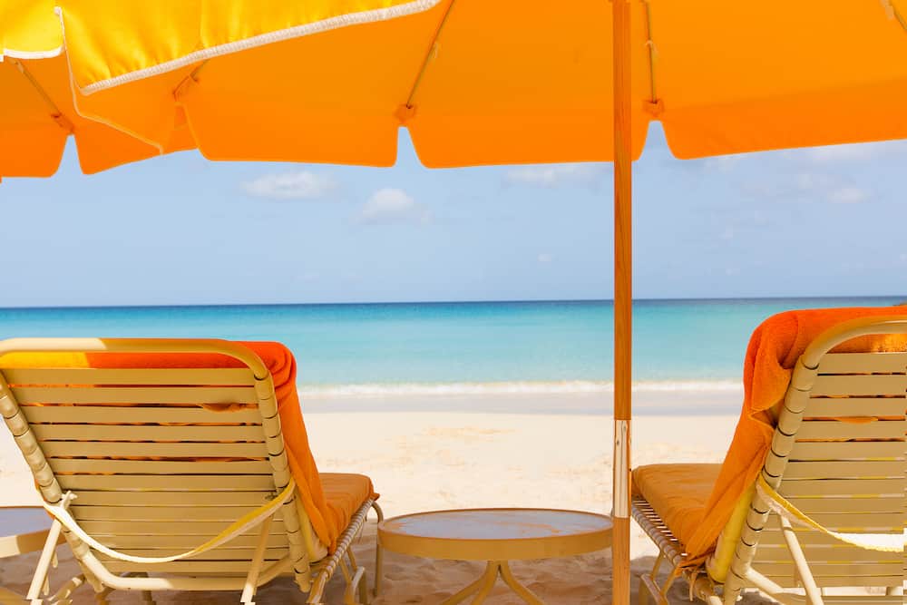 view at sunbeds and umbrella at perfect caribbean beach at anguilla island