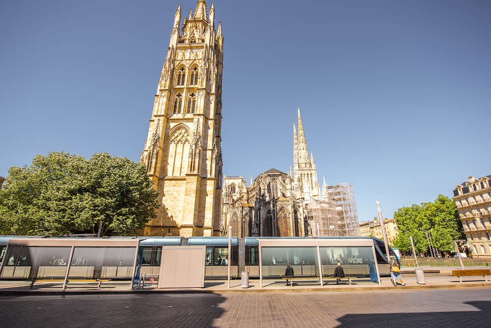 View on the square with saint Pierre cathedral and tram station in Bordeaux city, France