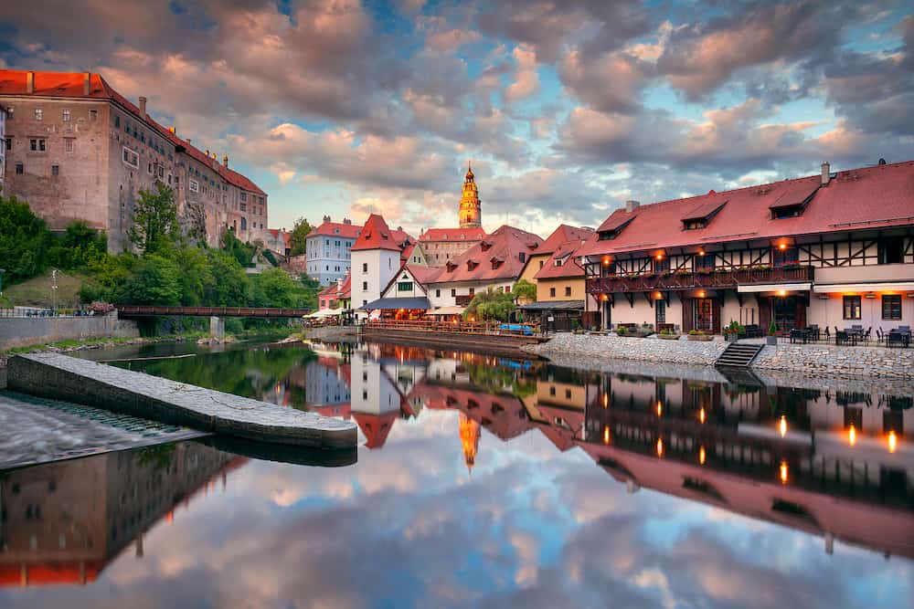 Cesky Krumlov. Cityscape image of downtown Cesky Krumlov, Czech Republic with reflection of the city in Vltava River at summer sunset.