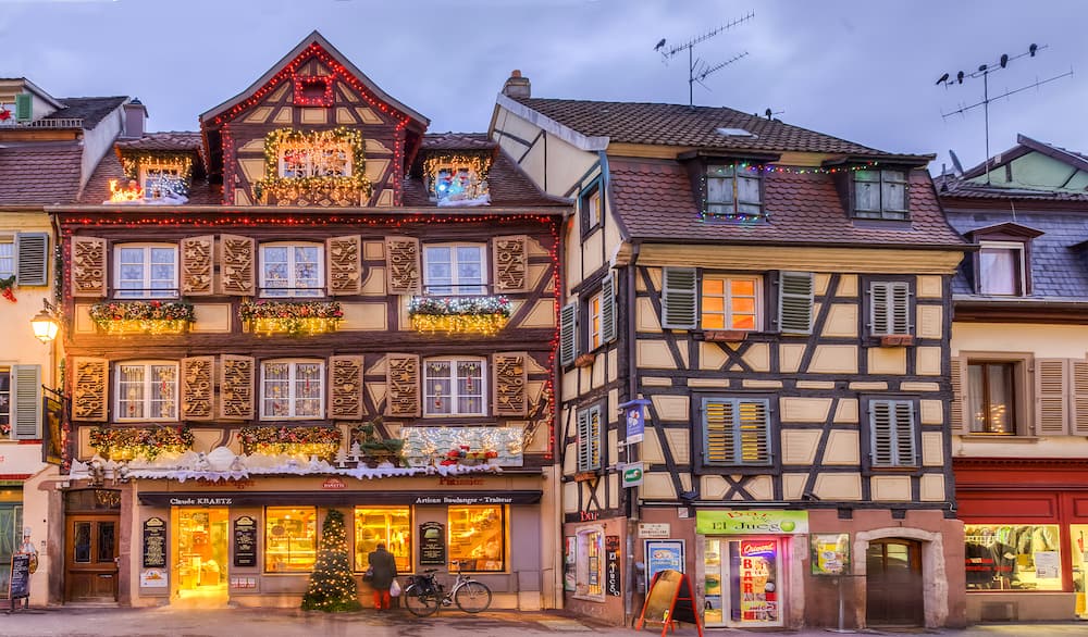 COlmarFrance- Image of traditional Alsatian half-timbered houses decorated in winter holidays in Colmar France