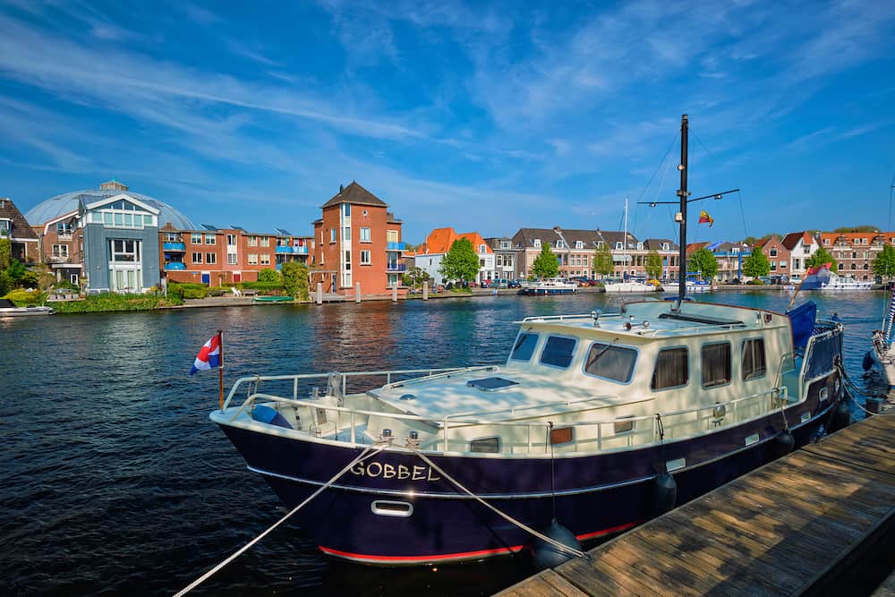 HAARLEM, NETHERLANDS - Spaarne river with boat moorned at quay in Haarlem, Netherlands