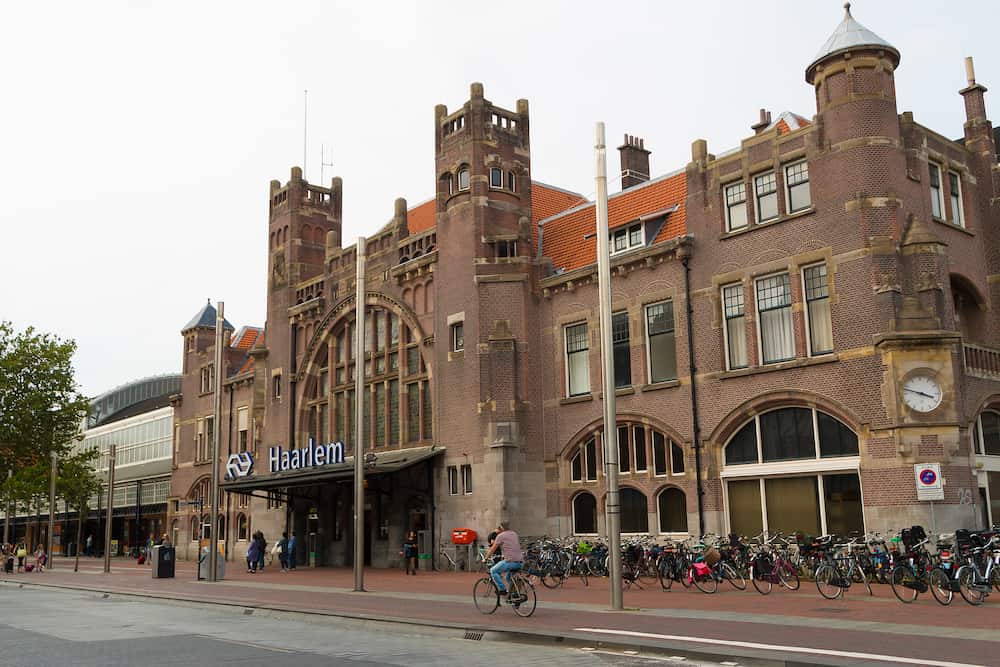 Haarlem, The Netherlands - historic style dutch architecture of Haarlem central train station with cyclist in foreground