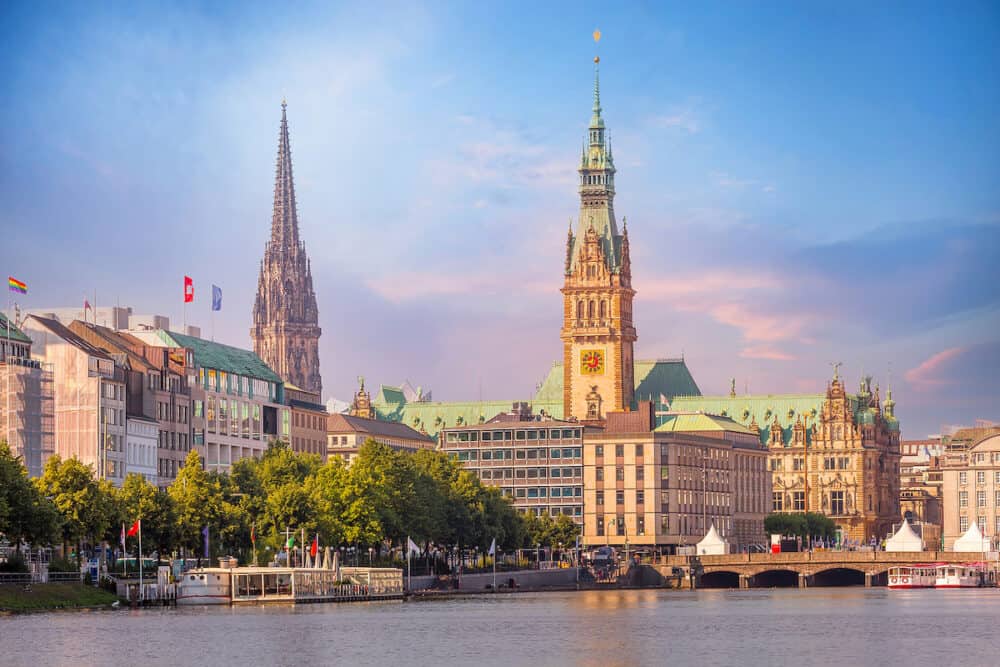 Hamburg, Germany colorful pink sunset or sunrise view of city center with Rathaus town hall and Alster lake