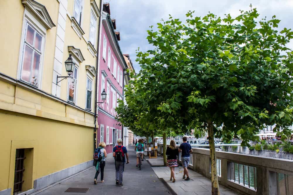 Ljubljana, Slovenia - View of People Walking by the River in Ljubljana City Centre on a Sunny Day