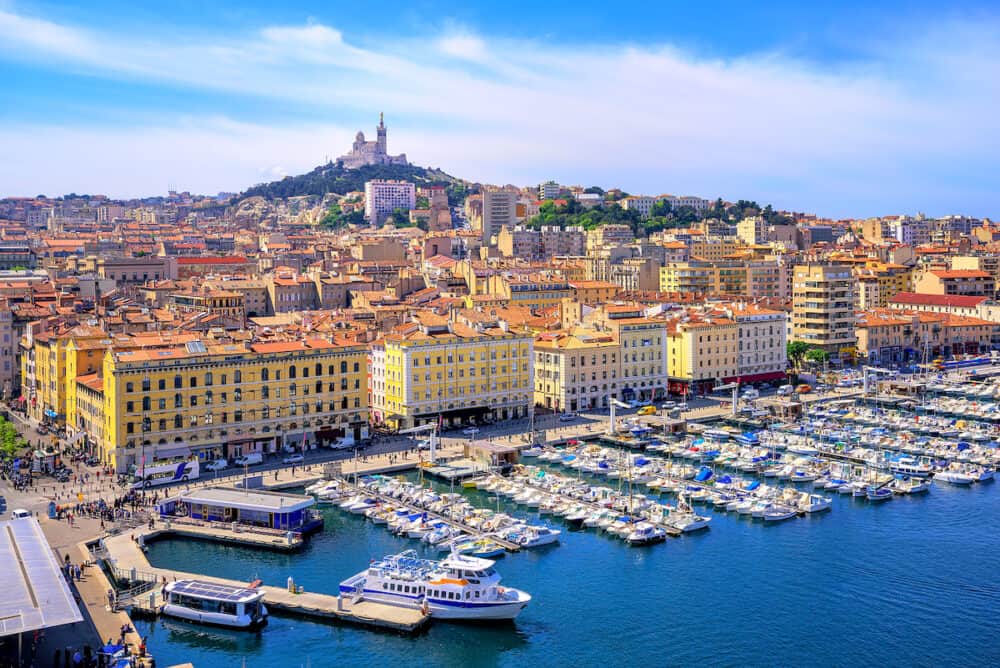 The old Vieux Port and Basilica Notre Dame de la Garde in the historical city center of Marseilles France