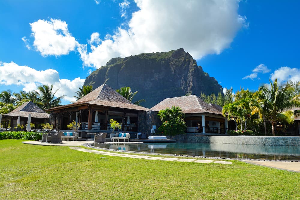 Le Morne, Mauritius - Pool and restaurant in luxury hotel with famous mountain Le Morne Brabant on background, Mauritius island