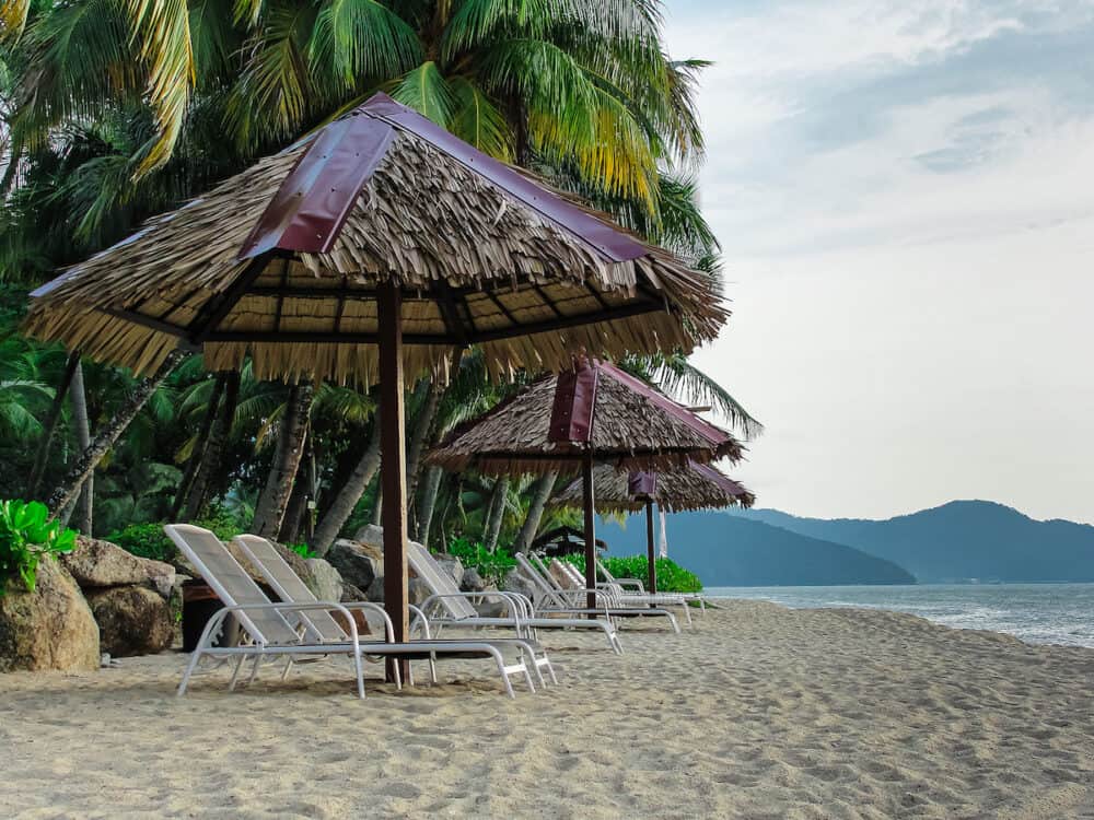 Batu Ferringhi beach, Penang Malaysia Sunbeds palms sea ocean mountains sand, travel photo