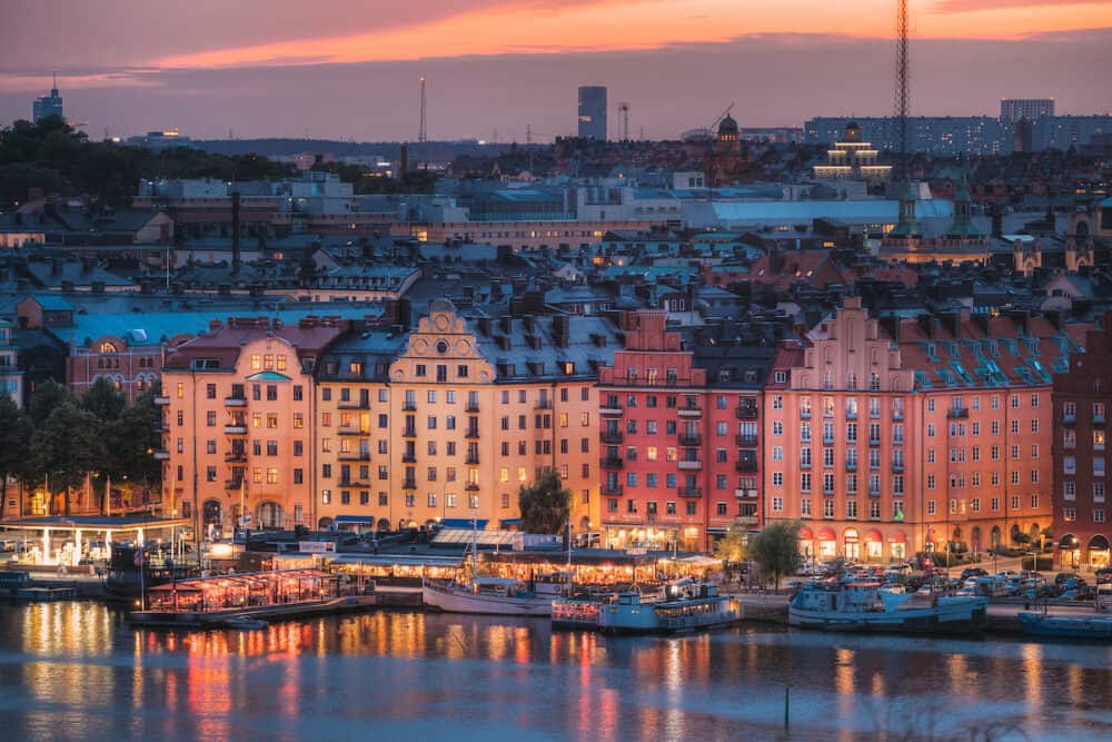 Stockholm, Sweden -  Skyline View Of Residential Area Houses In Norr Malarstrand Street, Kungsholmen Island. Scenic View In Sunset Twilight Dusk Lights. Evening Lighting.