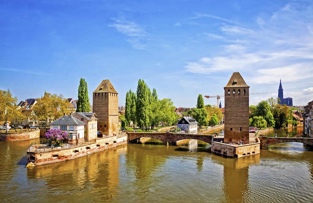Three bridges and two towers of the medieval bridge Ponts Couverts in Strasbourg city, Alsace, France. Springtime view from the panoramic terrace of Barrage Vauban