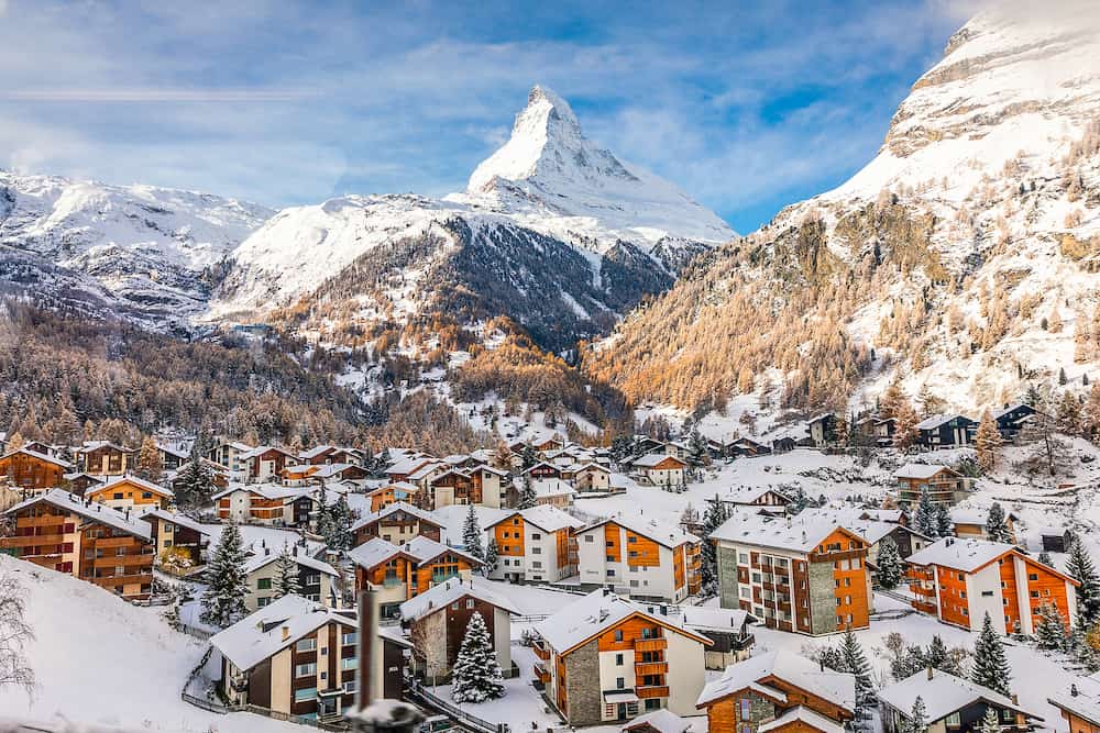 Zermatt, Switzerland - Aerial view of snowcapped village with background of iconic mountain peak Matterhorn, some hotels are closed in winter.