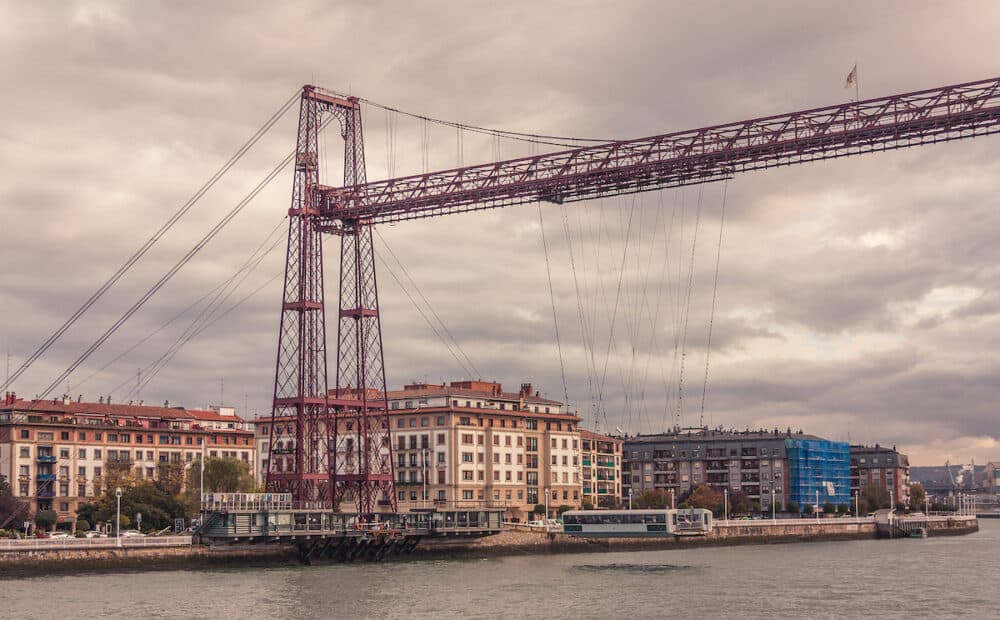 Getxo, Bilbao, Spain: Historic suspension bridge in the city of Getxo crossing the river for the transport of vehicles and people from one side of the city to the other