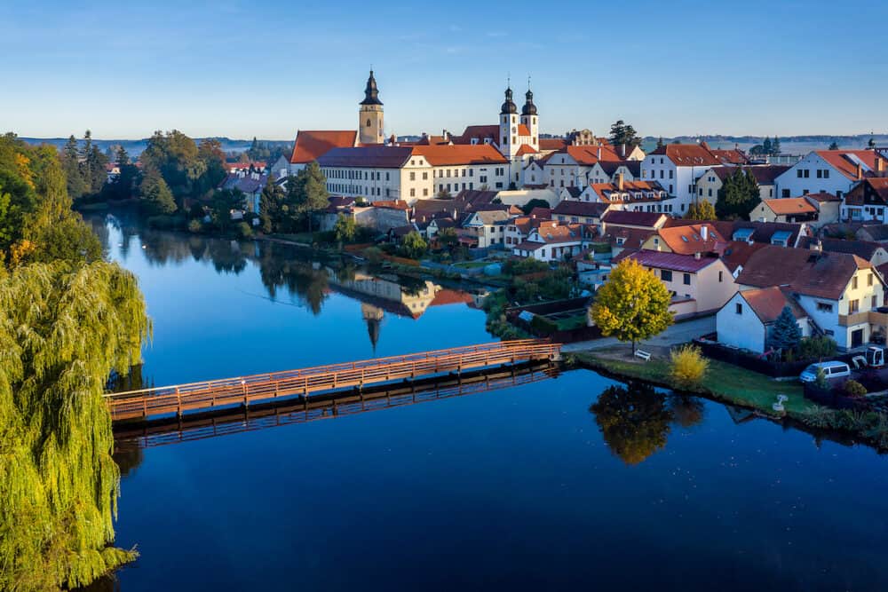 Aerial view just after sunrise of the pond and bridge in front of the Telc castle in the Czech Republic.