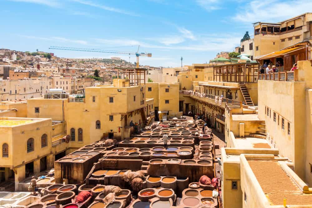 Fez Morocco -  Workers are dyeing leather at the tannery in Fez Fes el Bali Morocco Africa
