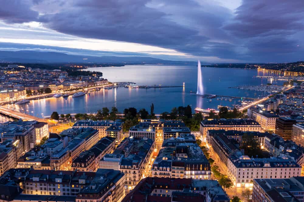 Aerial night view of Geneva city waterfront skyline in Switzerland